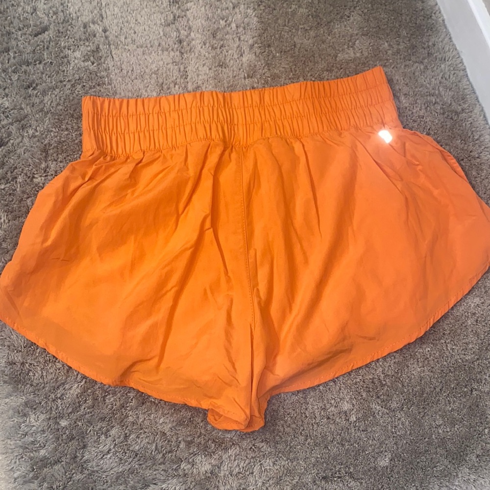 Orange running shorts with pocket shorts under